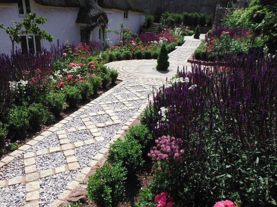 Cottage garden planting either side of a traditional zig-zag path in Shaldon, Devon. 